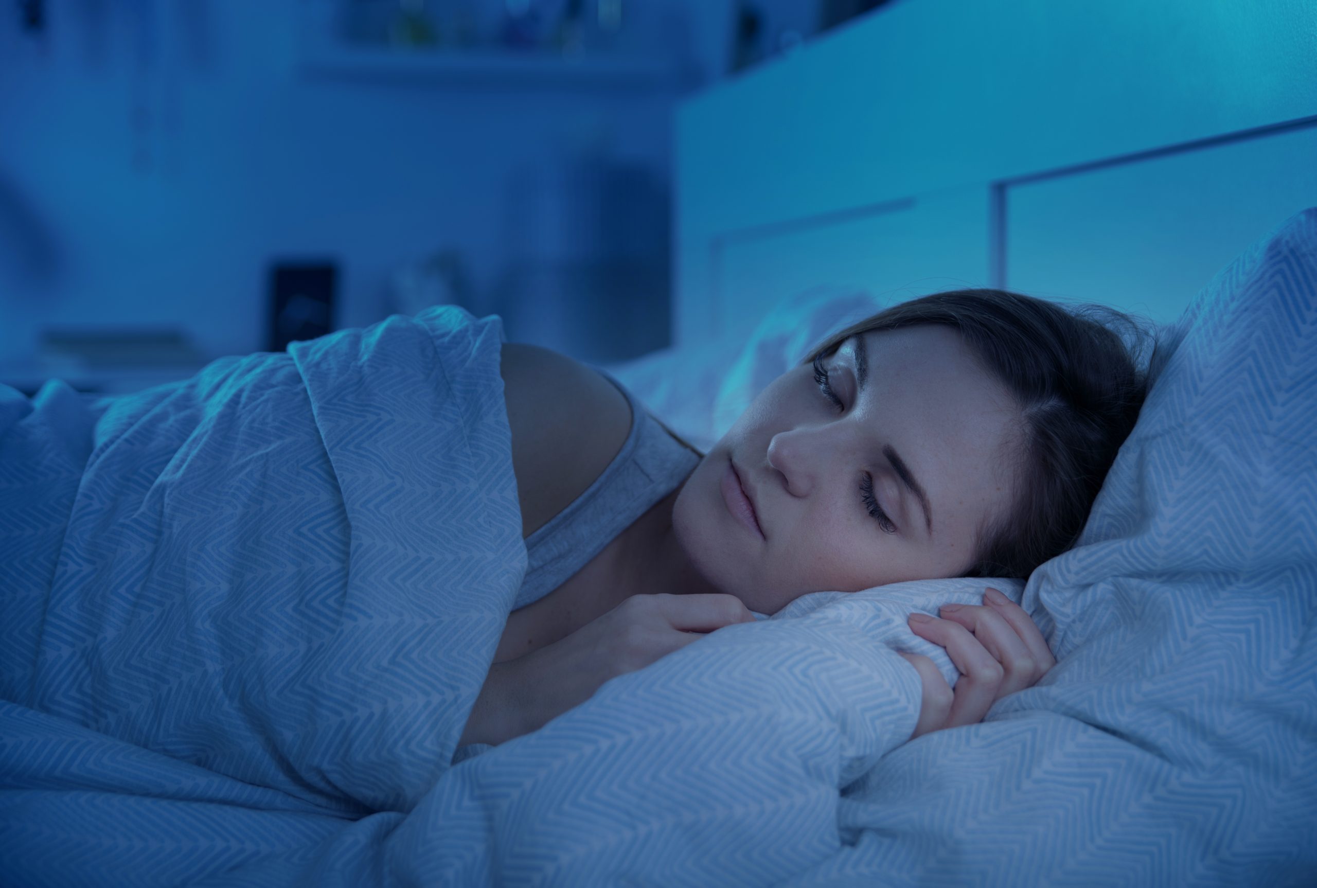 Woman,Peacefully,Sleeping,In,Bed,At,Night