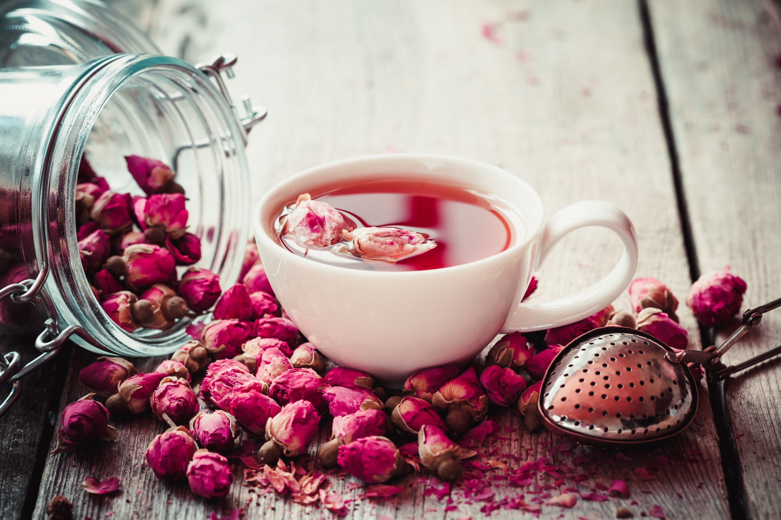 Rose,Buds,Tea,,Tea,Cup,,Strainer,And,Glass,Jar,With